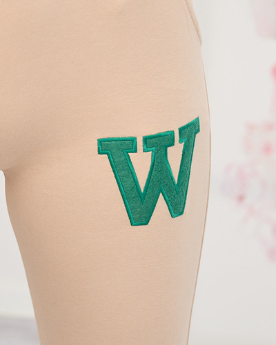 Moteriškos smėlio spalvos sportinės kelnės su spalvotu pleistru - Drabužiai