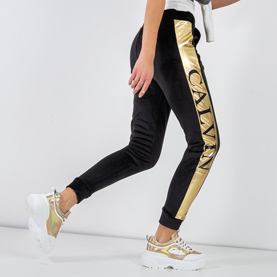 Женские черные утепленные спортивные брюки с золотыми полосками - Odież