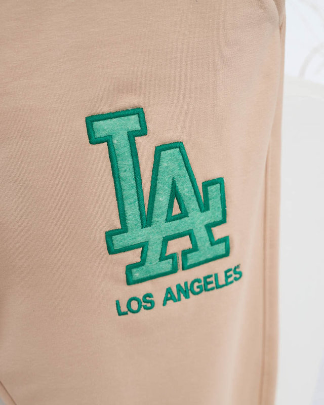 Женские бежевые спортивные штаны с цветной нашивкой - Одежда