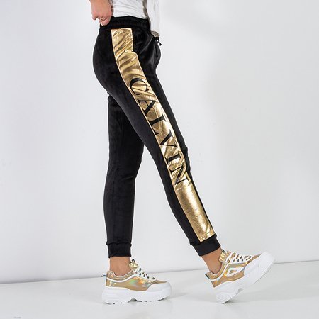 Женские черные утепленные спортивные брюки с золотыми полосками - Odież